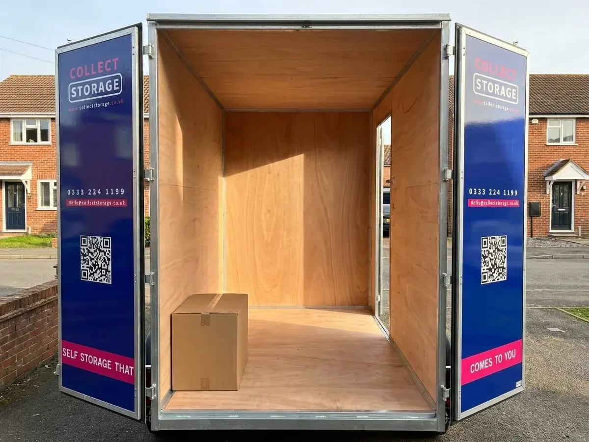 Inside an empty Collect Storage container with the doors open and a box for scale