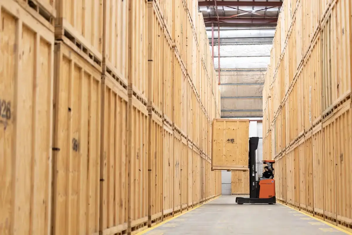 Wooden storage vaults being moved by forklift inside the Collect Storage facility