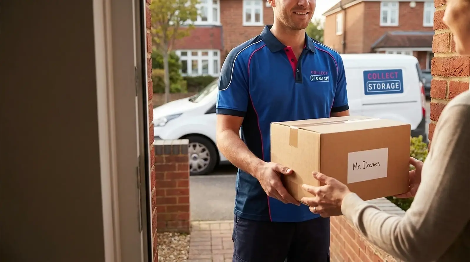A Collect Storage team member handing a labelled storage box to a customer at their door