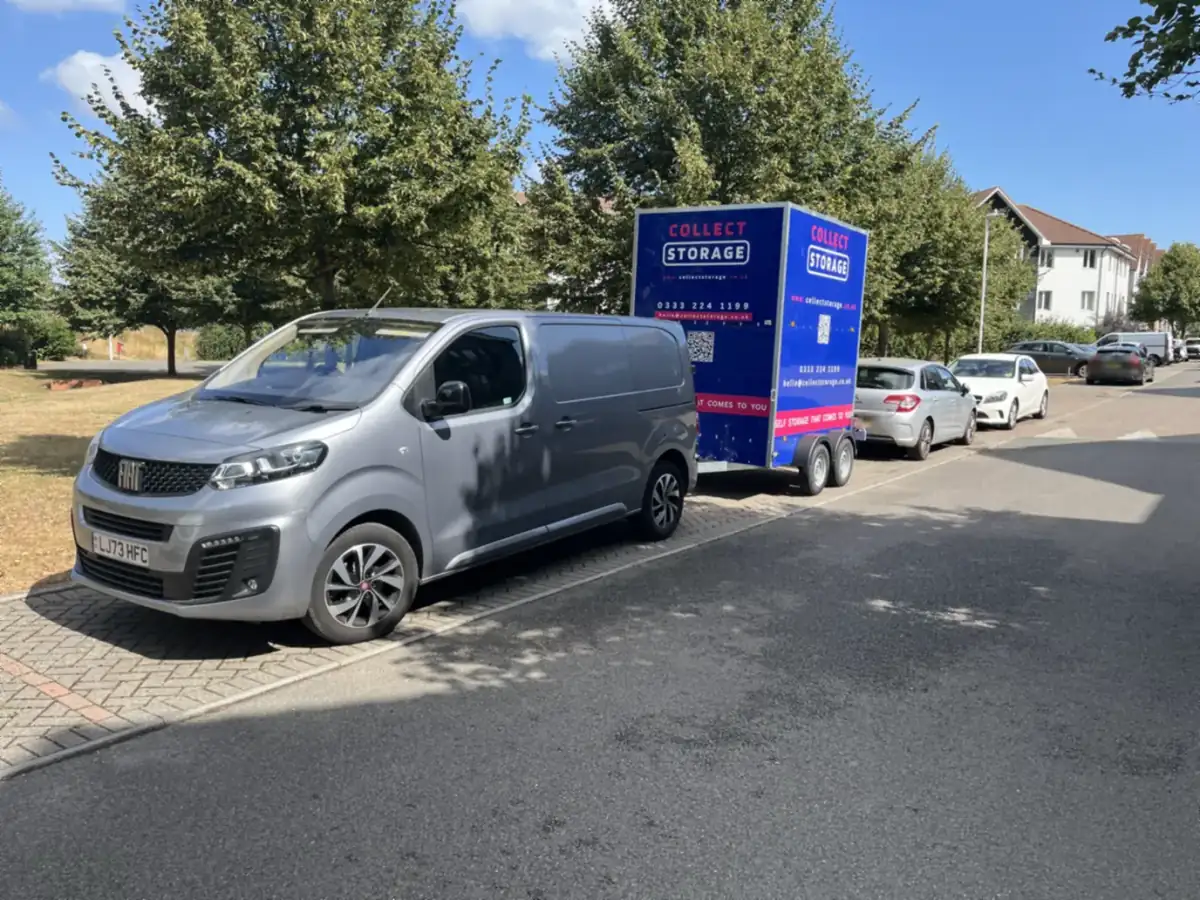 A Collect Storage van and liveried trailer parked on a residential street in Kent